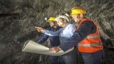 Miners working at the mine with an engineer representing mining share price