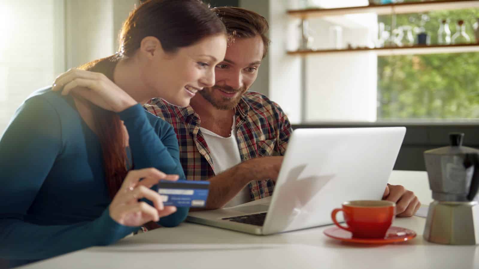A couple sitting at their laptop about to buy a product on online retail website Redbubble