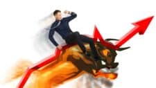 man riding bull on an upward trending arrow