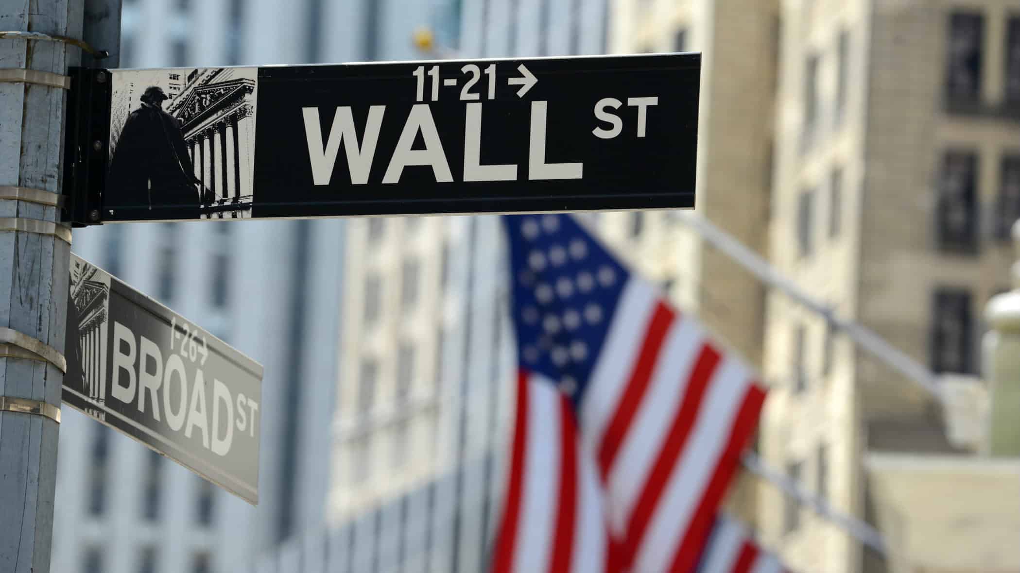 Wall Street sign in front of US flag