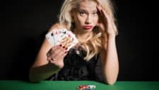 Falling asx share price represented by woman with bad poker hand at casino