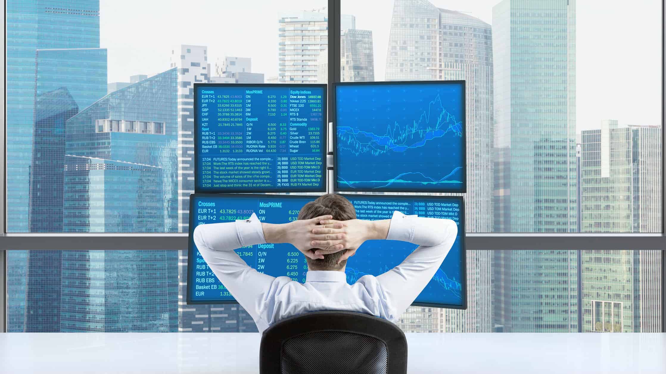 Broker trading shares relaxing looking at screen