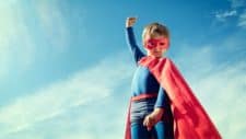 child in a superman outfit indicating a surge in share price