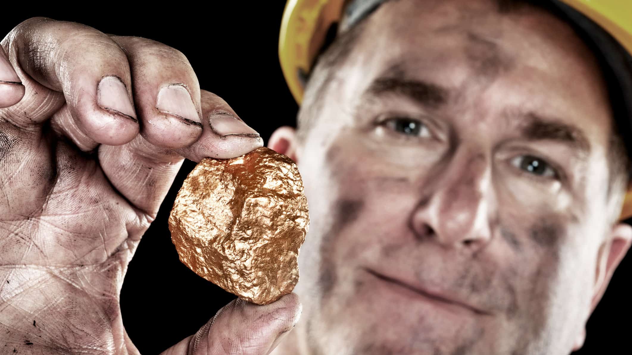 miner holding gold nugget