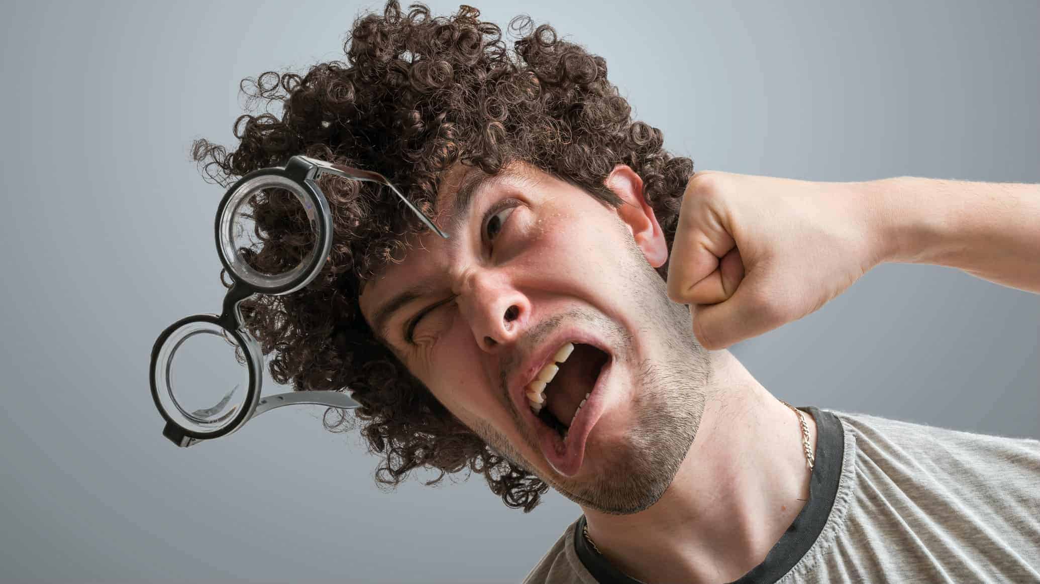 A man's glasses fall off his face as a fist delivers one almighty punch to his cheek.