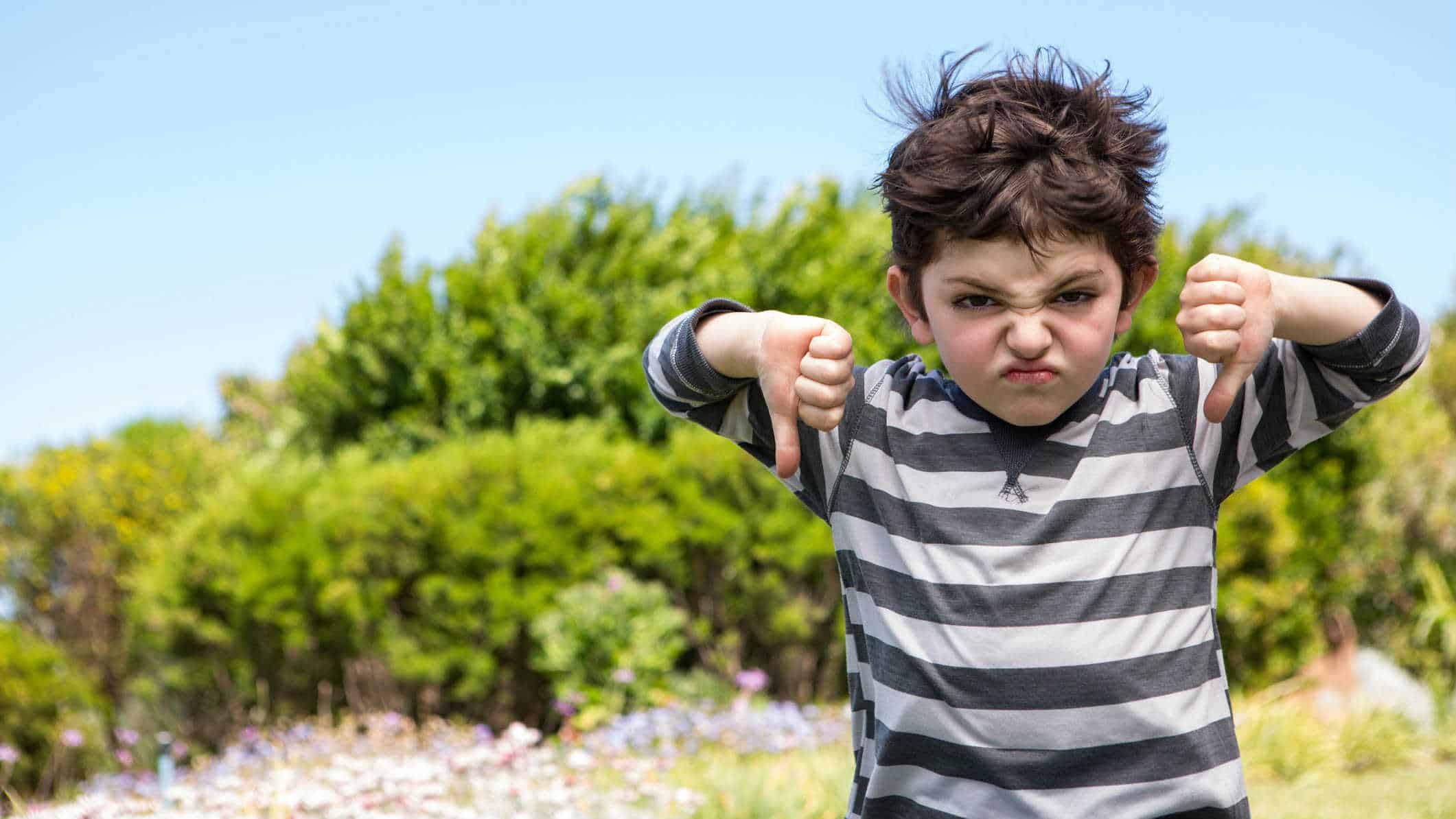 falling asx share price represented by child making thumbs down gesture with grimacing face