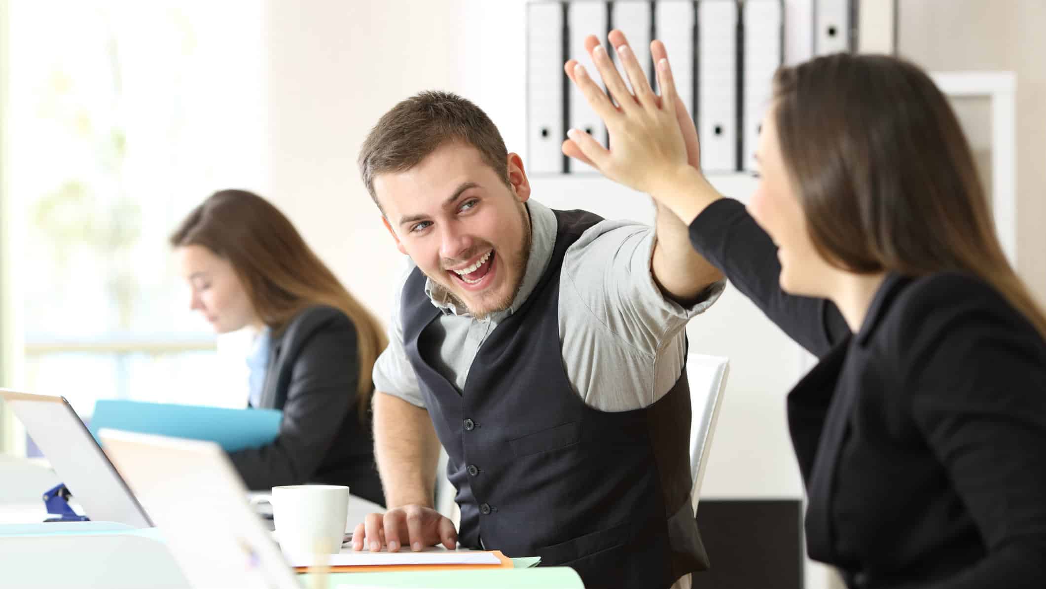Harmoney share price rise represented by two staffers high fiving in the office