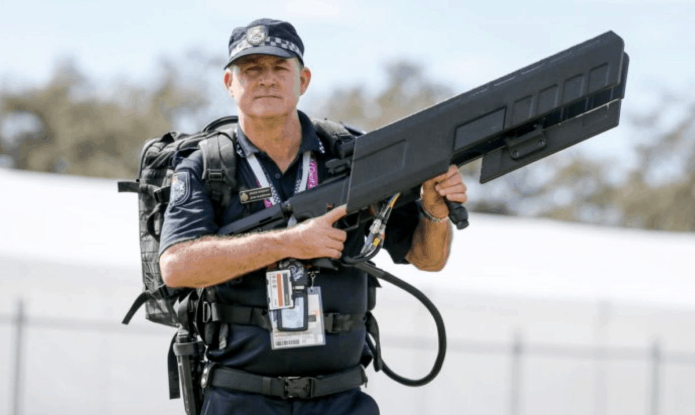 A police officer holds an Australian-made DroneGun Tactical anti-drone device
