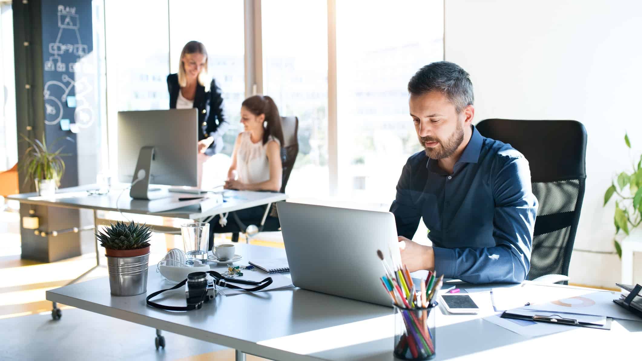 People working in an office on their computers and laptops