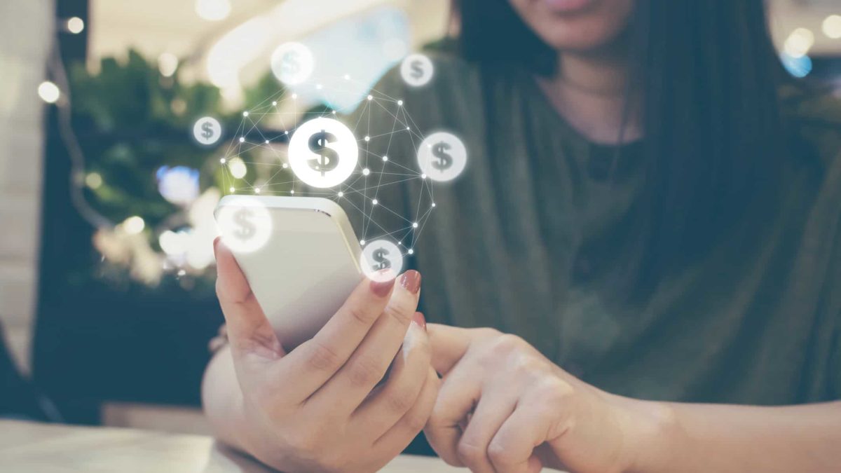 Woman holding smartphone with digital payment capability