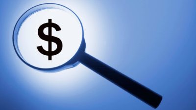 maginfying glass over dollar sign