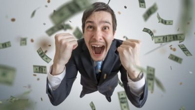 Investing in ASX shares for passive income represented by excited man surrounded by flying money notes