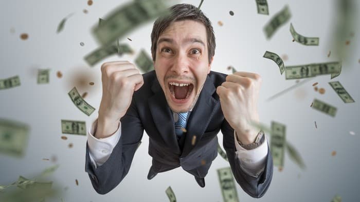 Investing in ASX shares for passive income represented by excited man surrounded by flying money notes
