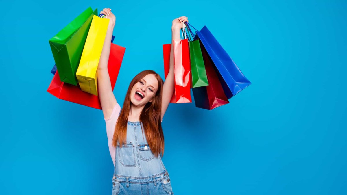 young excited woman holding shopping bags SCA profit dividend results
