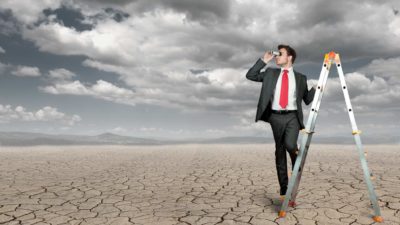 businessman searching for opportunity in drought conditions