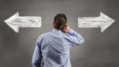 Man choosing between two options with arrows