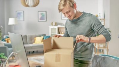 Man opening Walmart package in home office