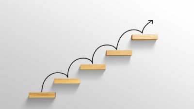 ASX share price growth represented by rising arrow on staircase