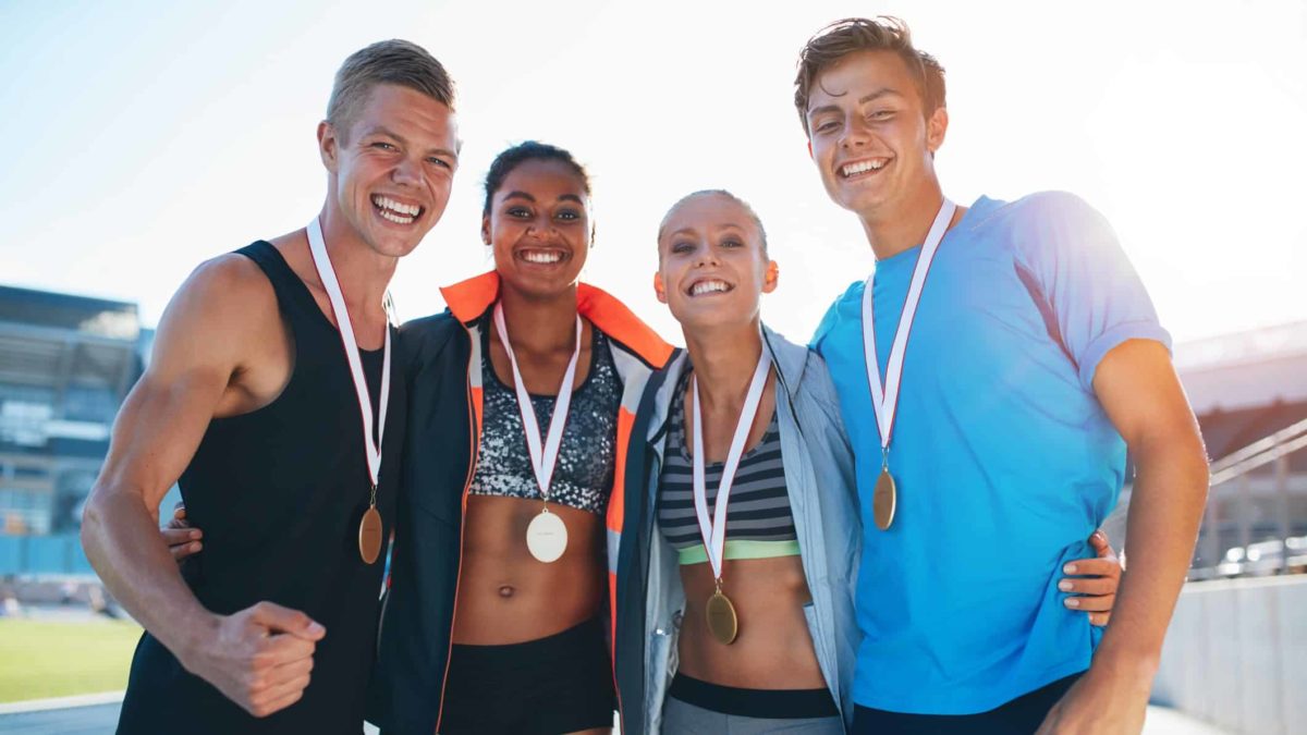 4 athletes wearing medals