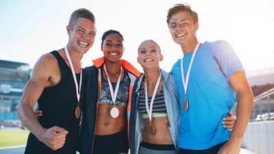 4 athletes wearing medals
