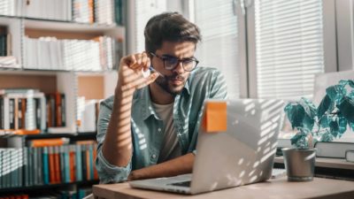 male looking at laptop with confused expression