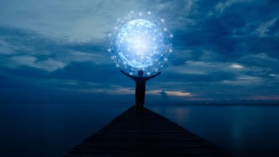 silhouette of person holding world above head