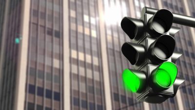 Green traffic light in front of city office building