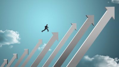 man jumps up a chart, indicating share price going up on the ASX bank dividend