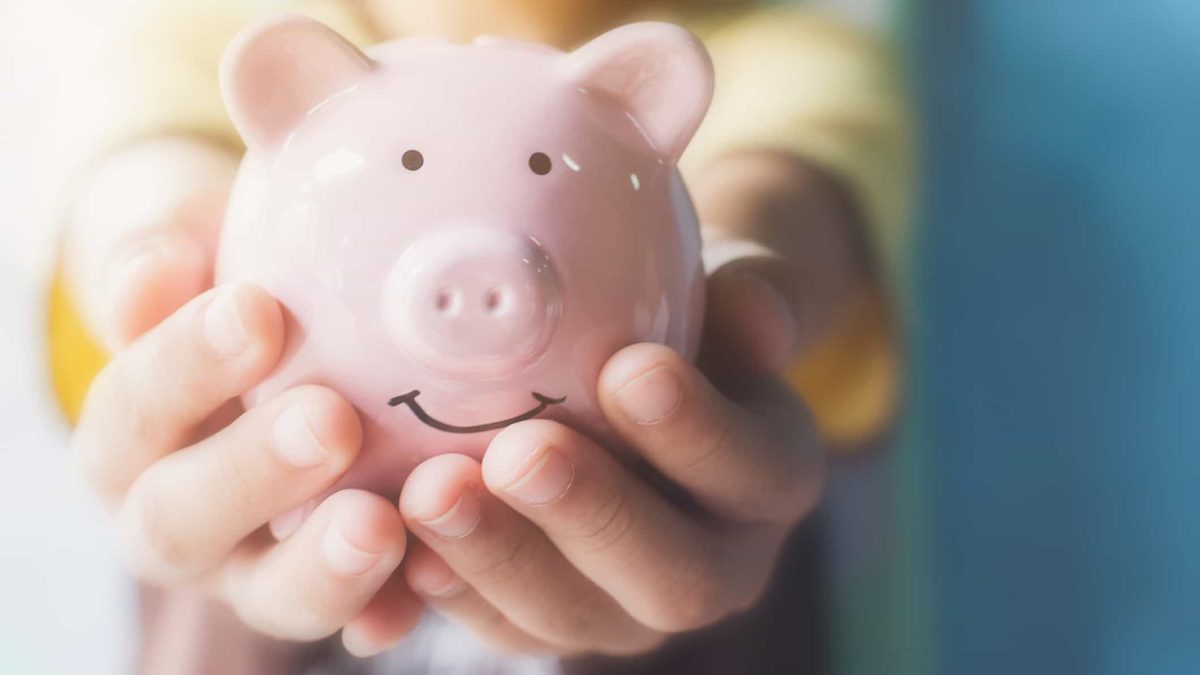 Holding piggy bank in hands, long term shares, shares to buy and hold