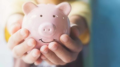 Holding piggy bank in hands, long term shares, shares to buy and hold