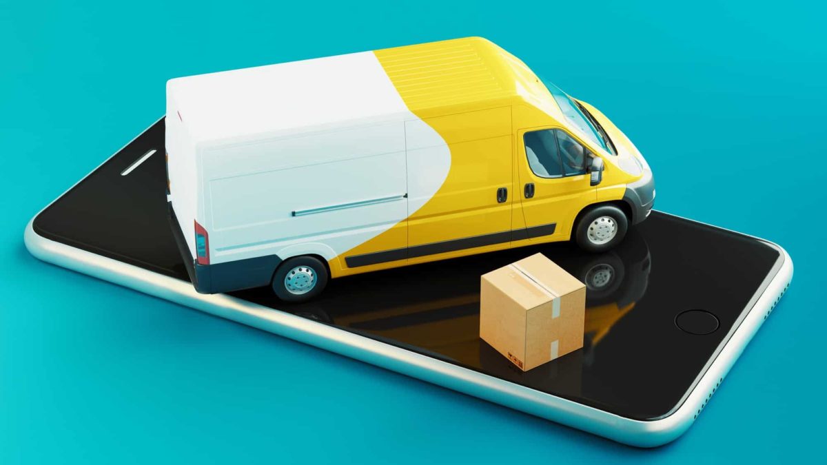 Small toy delivery van and box sitting on top of a smartphone