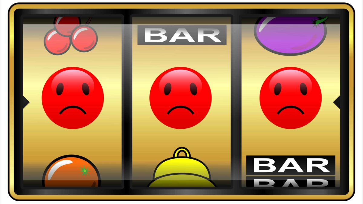 three sad face icons on a gaming machine