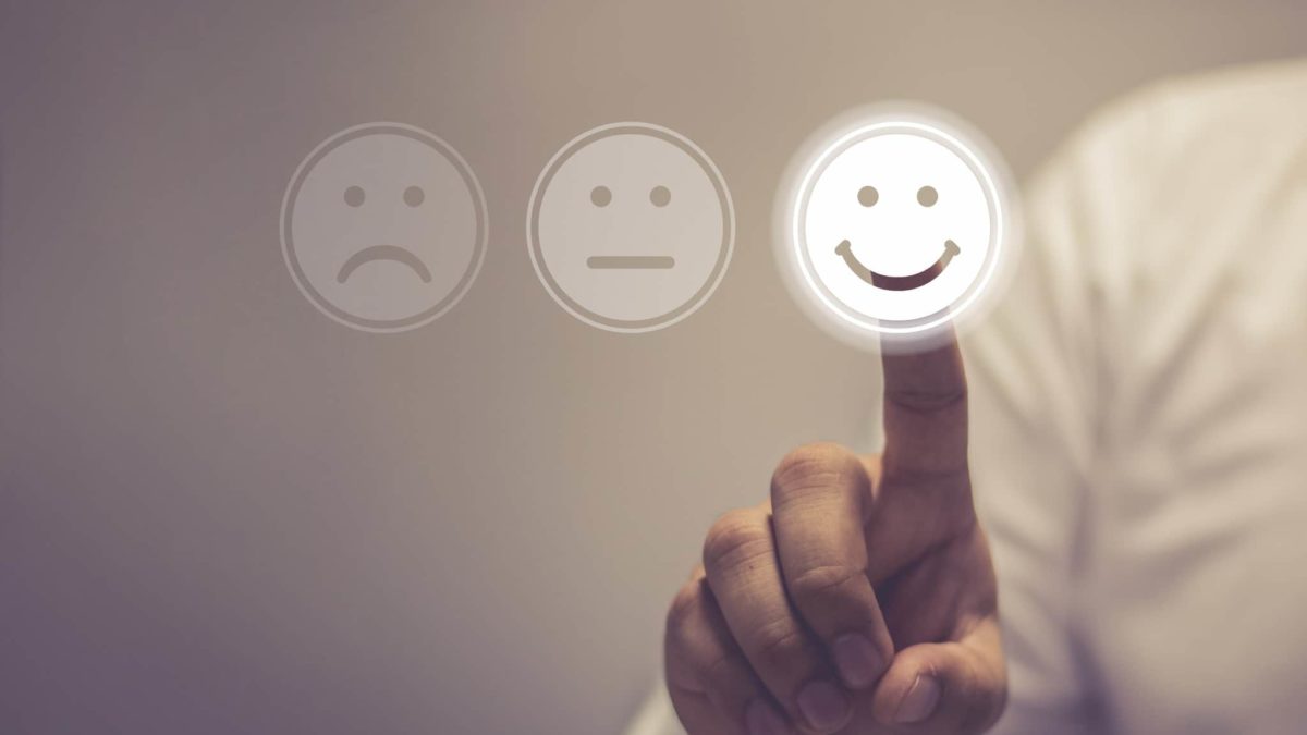 Man in white business shirt touches screen with happy smile symbol IGO share price upgrade