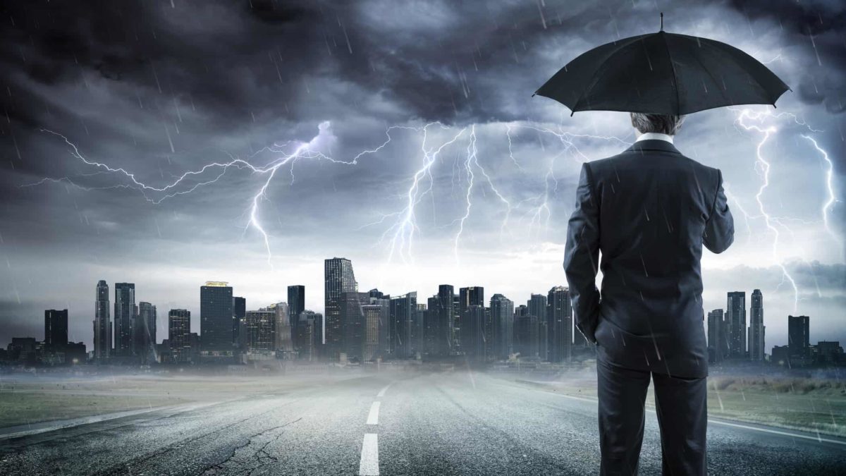 IAG share price man holding umbrella looking at storm over city, recession, asx 200 shares