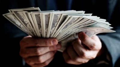 Close up of hands holding US bank notes