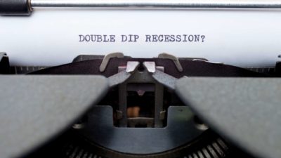 old fashioned type writer with paper stating double dip recession?