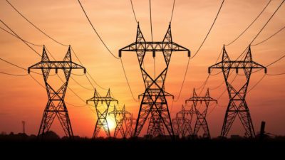 Power lines with a sunset in the background