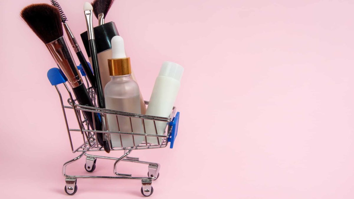 miniature shopping trolley filled with cosmetic items