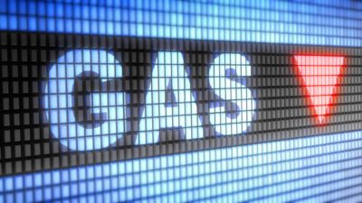 The word gas on stock market board with red down arrow