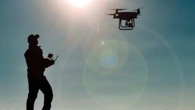 flying asx share price represented by man flying remote control drone