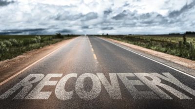 road in the country with word recovery printed on it