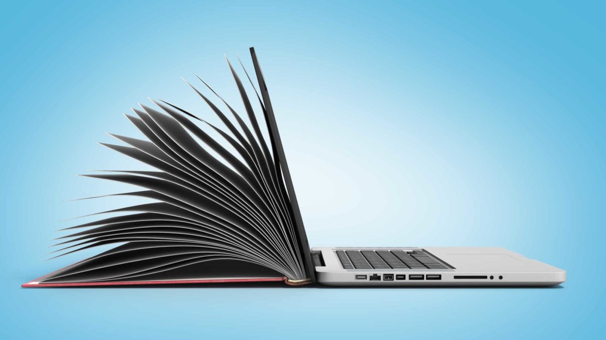 laptop computer with lid appearing like the paghes of a book representing online learning