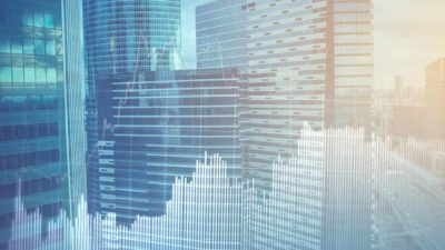 A photo of high rise offices with share market graphic overlaid
