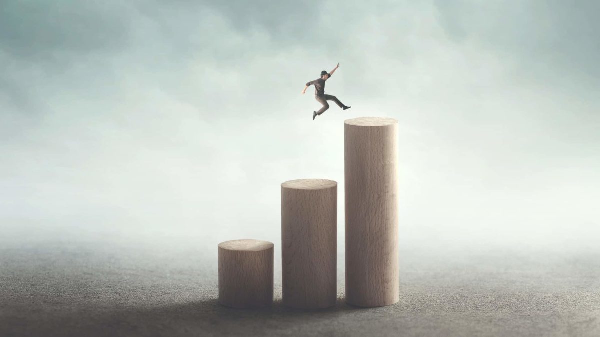 man jumping along increasing bar graph signifying jump in alumina share price