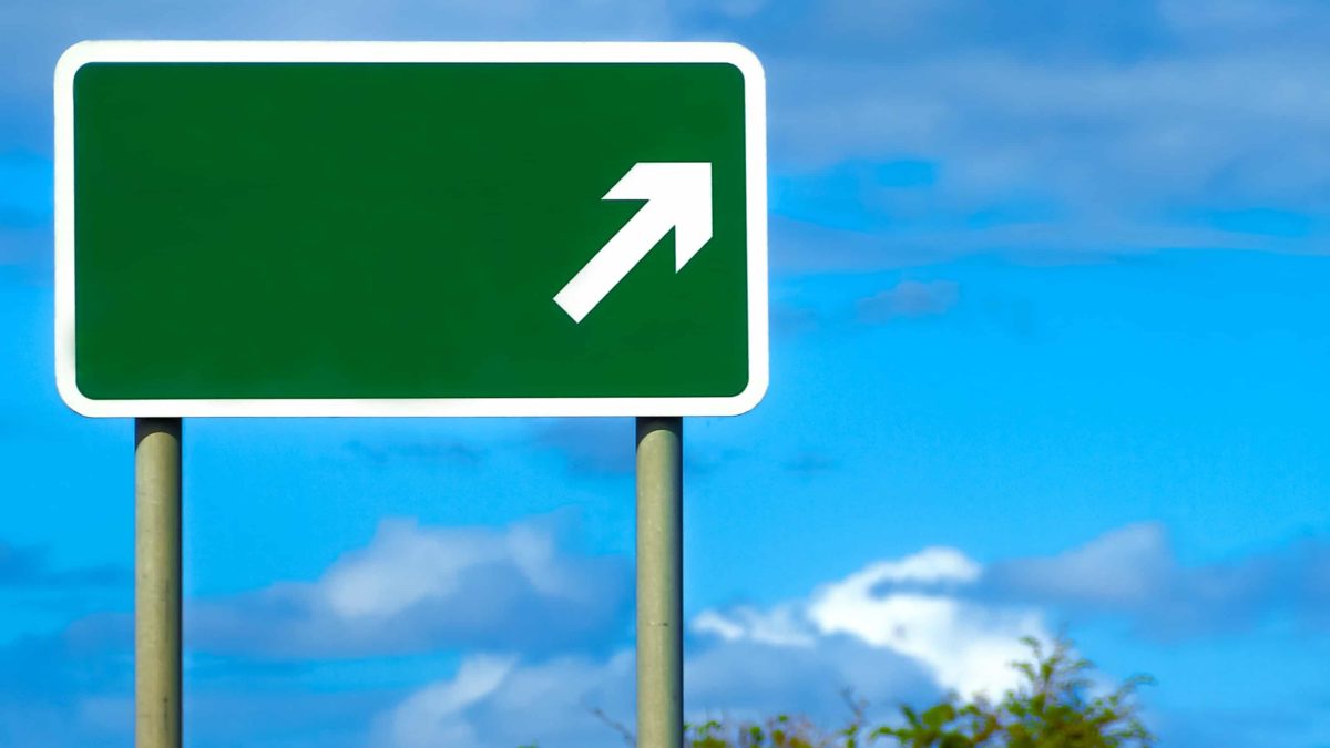 green road sign with white up arrow representing rising atlas arteria share price