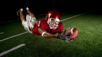man scoring touchdown in football game