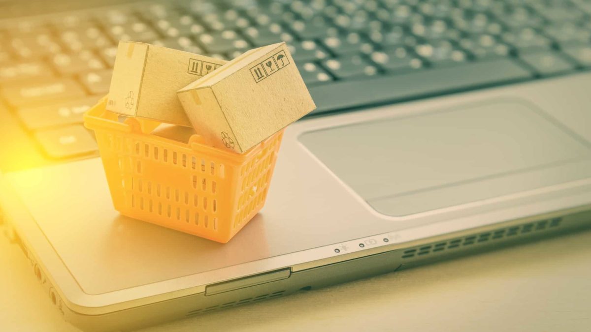 ASX e-commerce share price represented by miniature basket of parcels sitting on laptop keyboard