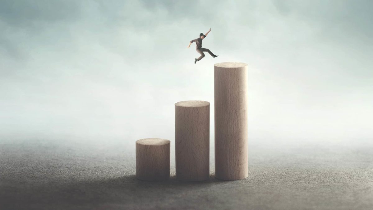 jump in asx share price represented by man leaping up from one wooden pillar to the next