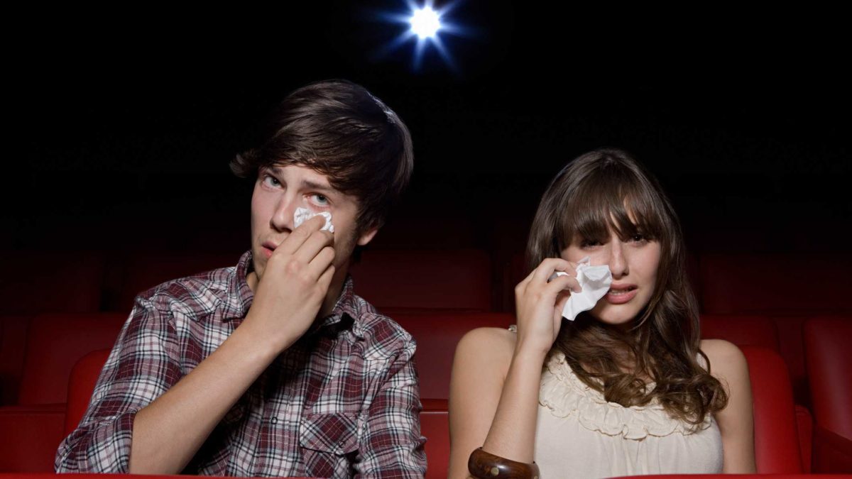 2 people sitting in a cinema crying representing falling village roadshow share price