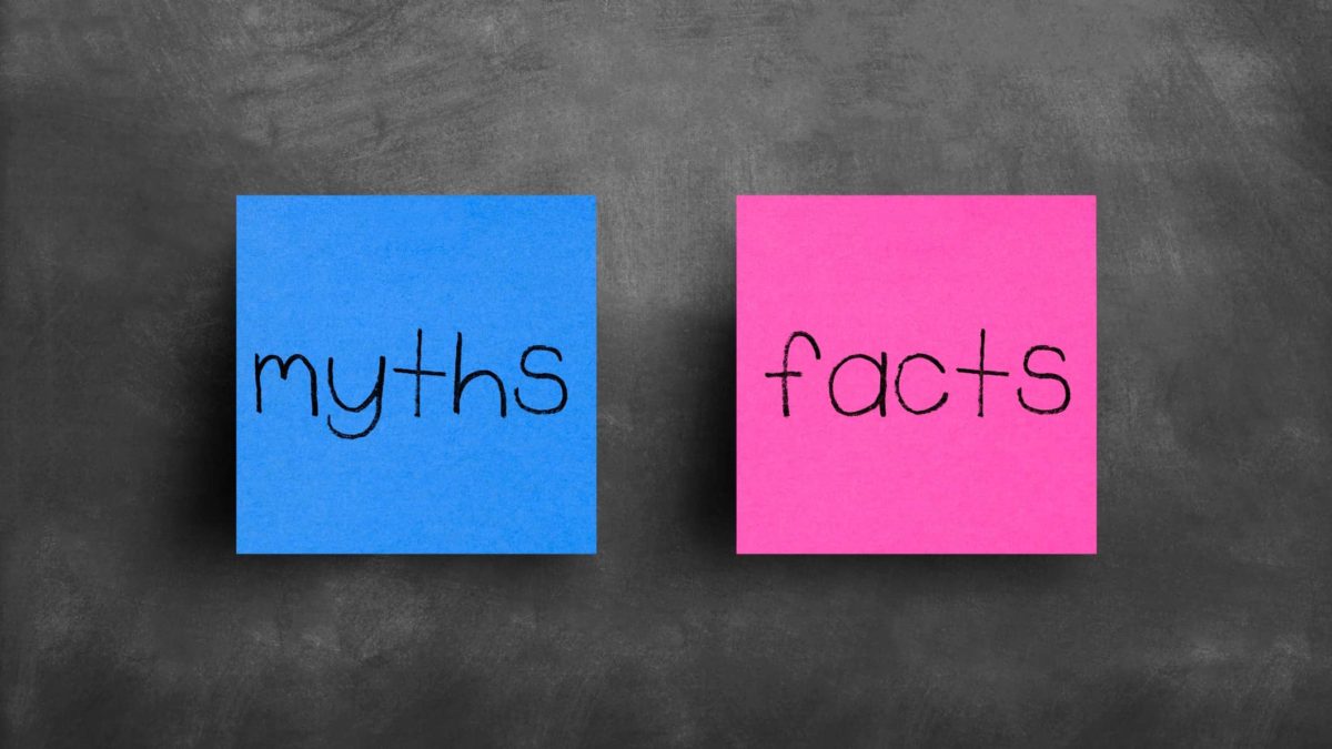 Blue post-it note with 'myths' written on it next to pink post-it note with 'facts' written on it